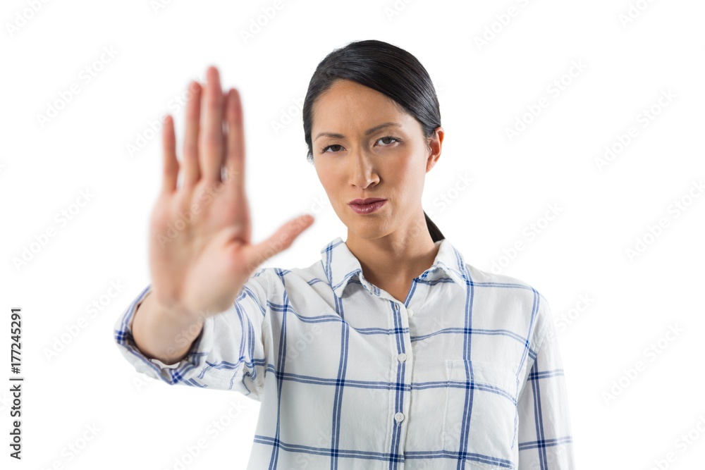 Woman showing stop sign against white background Woman showing stop sign against white background