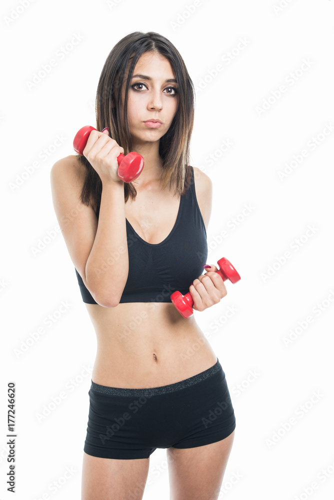 Portrait of fit girl posing with two dumbbells