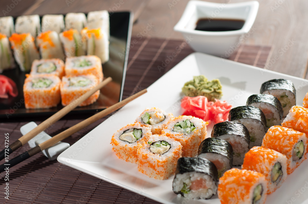 Sushi rolls on a black and white plate Sushi rolls on a black and white plate