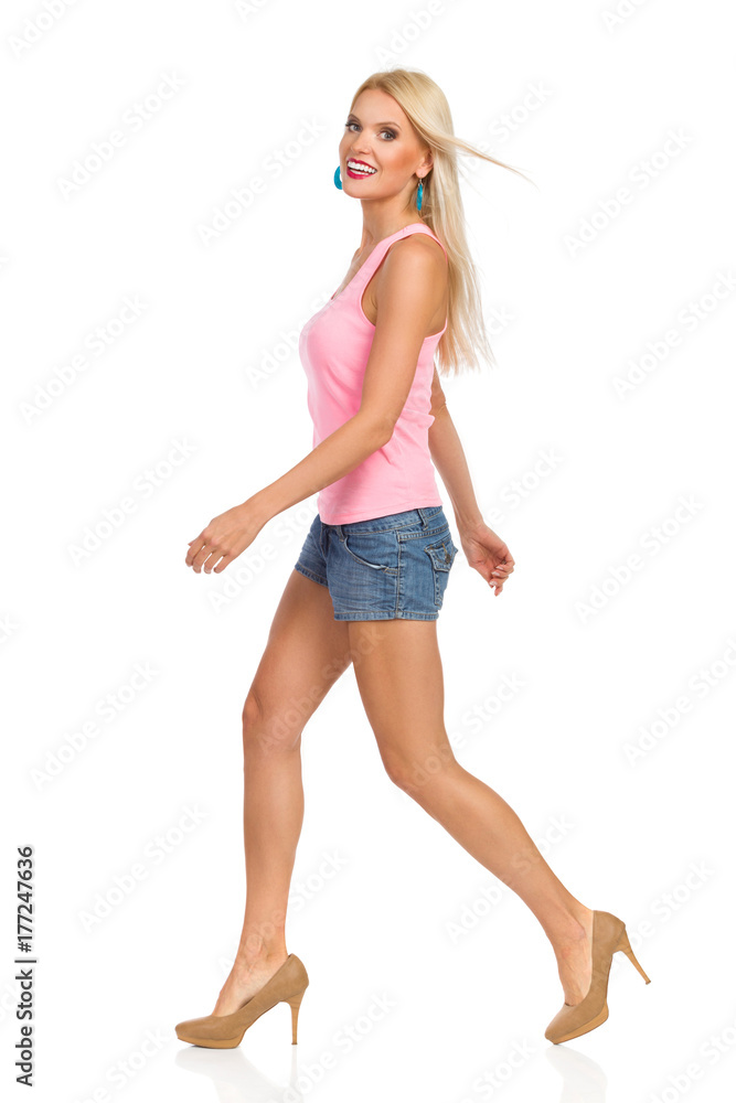 Beautiful Blond Smiling Woman Is Walking. Side View. Beautiful Blond Smiling Woman Is Walking. Side View.