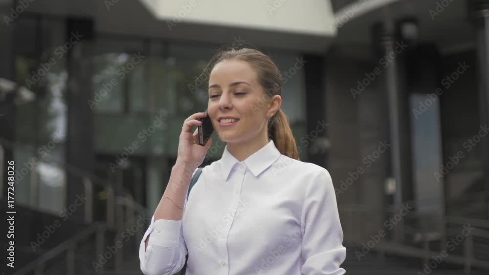 Girl walking in the city. talking on the phone Girl walking in the city. talking on the phone