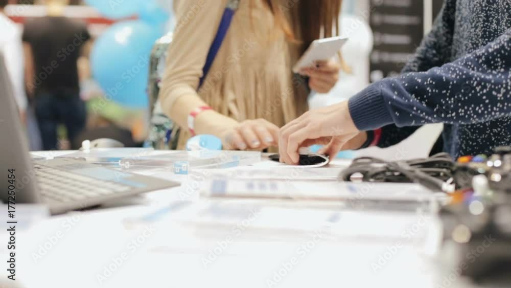 A girl buys a computer mouse in a store A girl buys a computer mouse in a store
