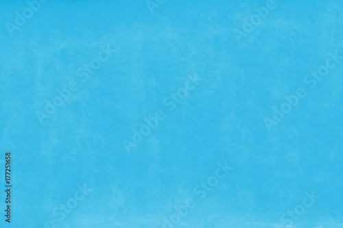 Light baby blue pastel color facade wall as an empty rustic background texture space.