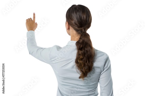 Female executive pretending to touch an invisible screen against