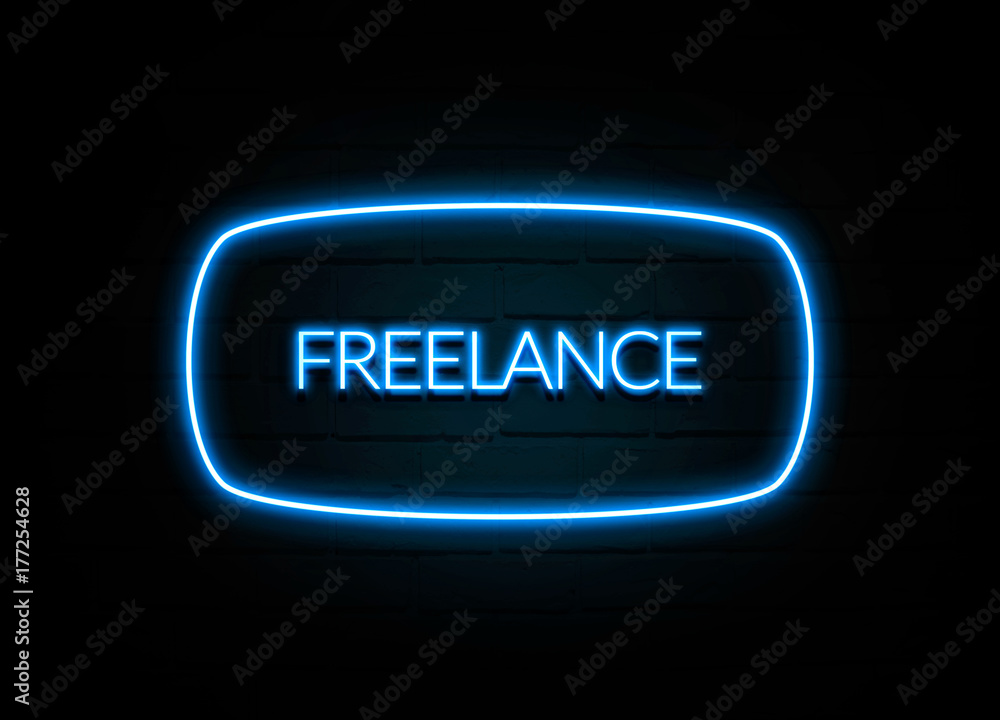Freelance - colorful Neon Sign on brickwall Freelance - colorful Neon Sign on brickwall
