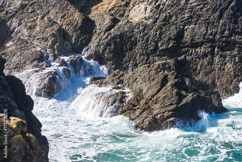 Waves crash into a small cove on the north Cornwall coast