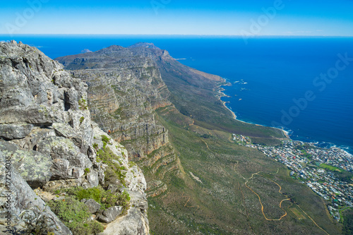 Woman climbing down Table Mountain, Atlantic Ocean and Twelve Apostles peaks © MaryK