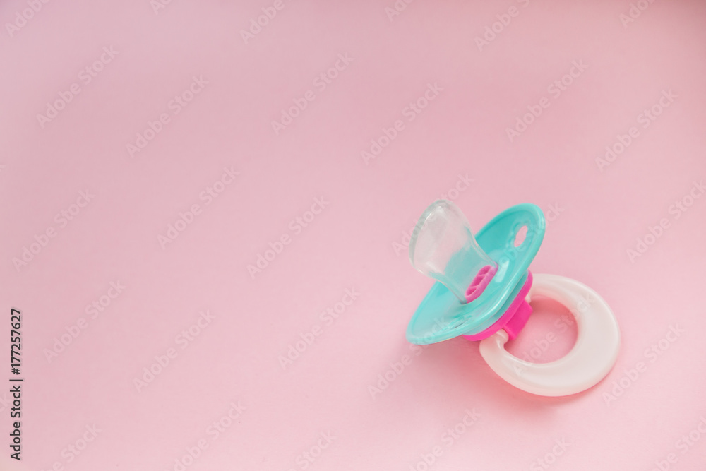 Baby Pacifier mint blue on pink background closeup. the baby stuff. place for text