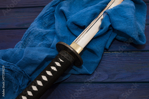 japan katana sword on the wood background with the blue shawl photo