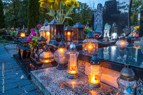 Fotografie Colorful candles on the cemetery at All Saints Day