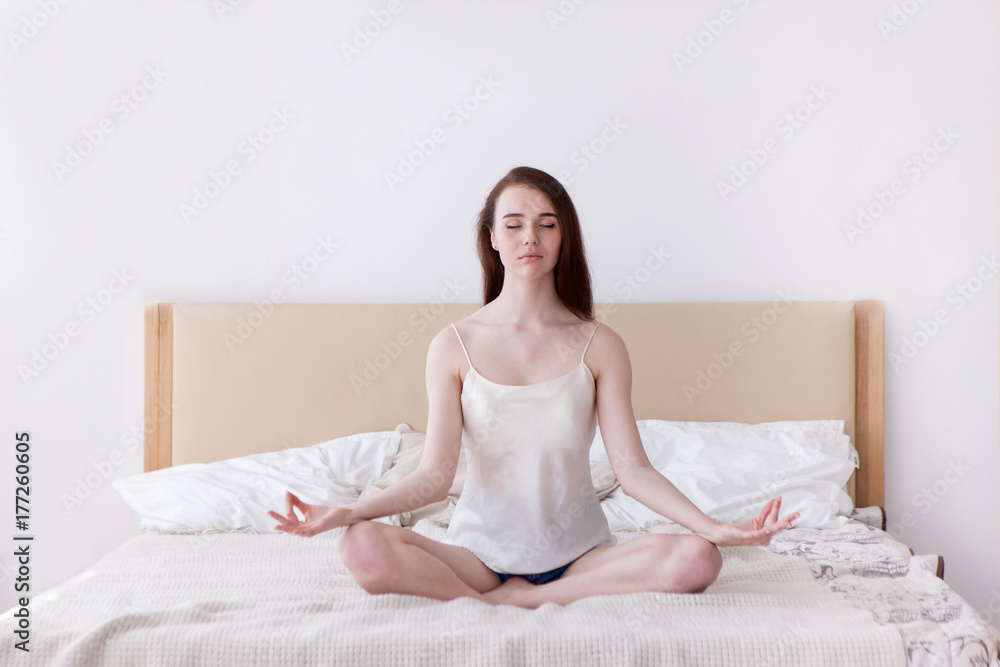 Resting yoga girl on bed concept. Harmony comfort morning at home. Self-confidence and calmness Resting yoga girl on bed concept. Harmony comfort morning at home. Self-confidence and calmness