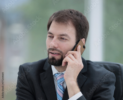 Mature smiling confident business man talking on the phone