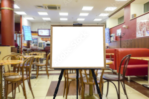 Cafe or restaurant, nobody of visitors. Defocused image. In the foreground is wooden frame as a place for your text.