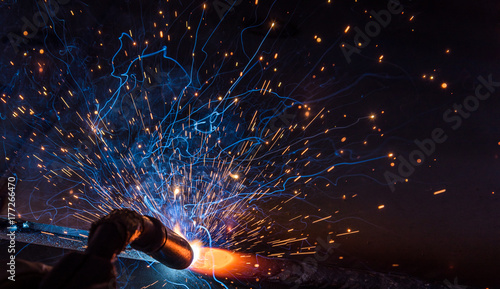 Fotografie Industrial steel welder in factory technical,