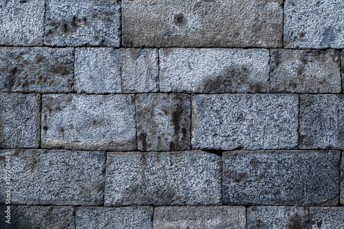 Old weathered stone tiles wall vintage background