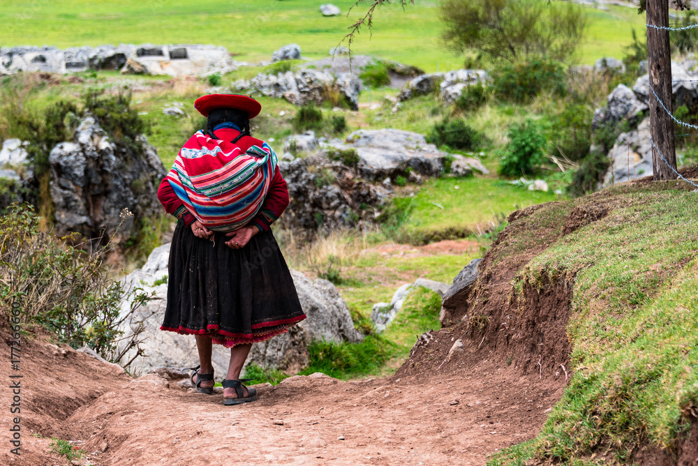 Fototapeta Local woman making her way to Saqsaywaman, Cusco, Peru.