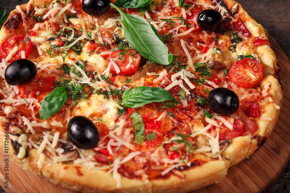 Fresh pizza with tomatoes, cheese and mushrooms on wooden table closeup Fresh pizza with tomatoes, cheese and mushrooms on wooden table closeup