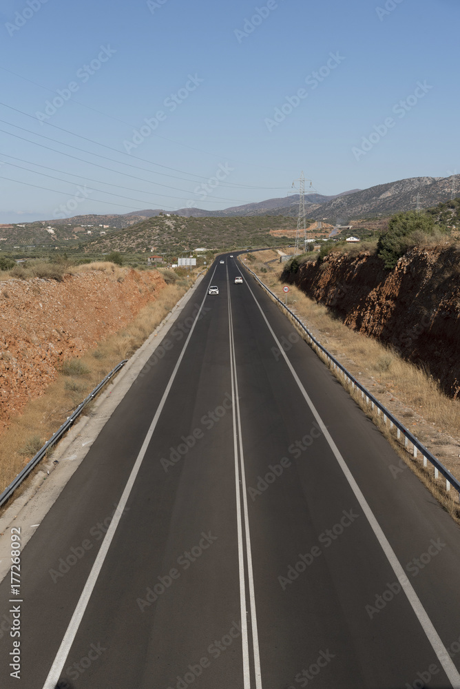 Malia, Crete, Greece. The E75 a National road with new road surface heading toward Agios Nikolaos. Malia, Crete, Greece. The E75 a National road with new road surface heading toward Agios Nikolaos.