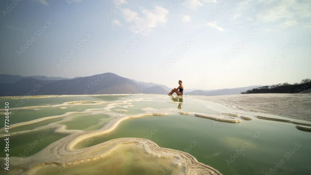 young women siting on the beautiful view in mauntain in natural mineral pool, Mexico Hierve el Agua