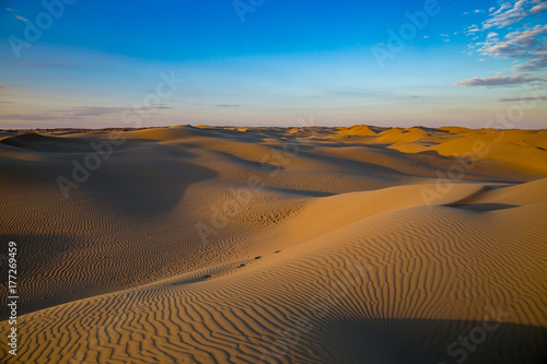 Natural beautiful desert landscape  sand dunes on blue evening sky background
