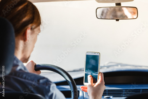 Man using his phone while driving car.