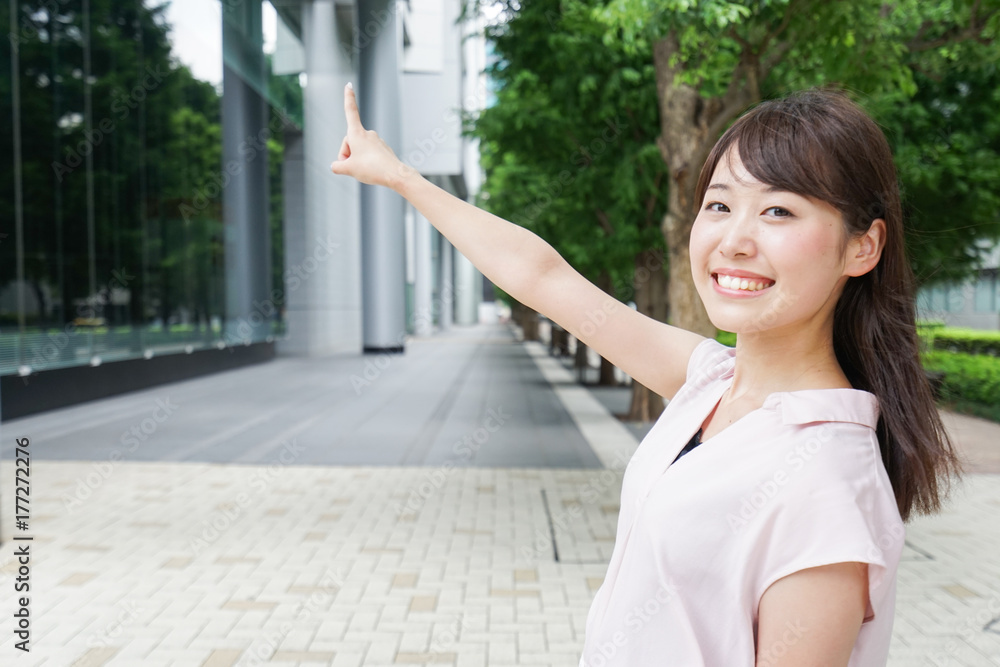 Young woman pointing on street