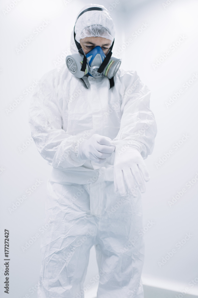 Scientist putting on gloves to work Scientist putting on gloves to work