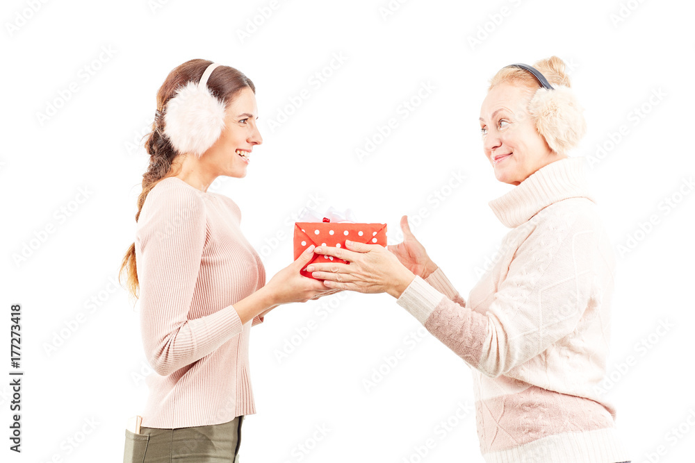Portrait of senior mother and adult daughter exchanging Christmas gifts Portrait of senior mother and adult daughter exchanging Christmas gifts