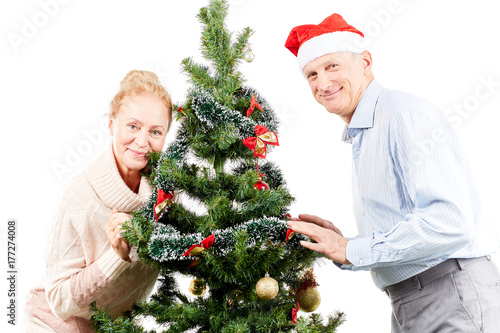 Portrait of senior couple posing near Christmas tree