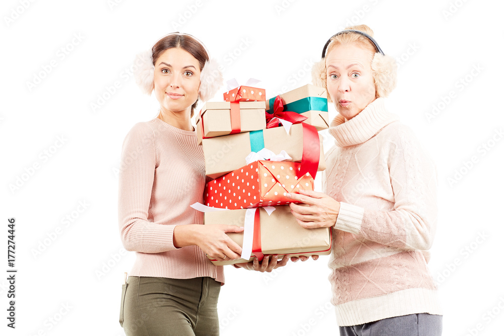Portrait of senior mother and adult daughter exchanging Christmas gifts Portrait of senior mother and adult daughter exchanging Christmas gifts