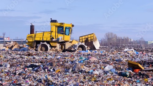 Waste, garbage, dump, rubbish 4K. A landfill compactor working at a lanfill site. photo