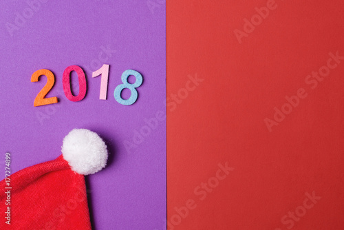 2018 colorful numbers and santa hat on paper backround, minimal style. photo