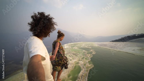 pov, young couple walking hand by hand on natural terrace in mauntain, Mexico Hierve el Agua photo