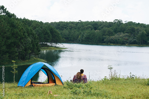 Tourists resting by lake