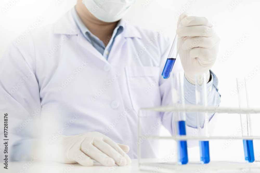 Fototapeta premium Asian scientific researcher working in laboratory holds test tube in hand a liquid solution analysis using chemical manufacturing.
