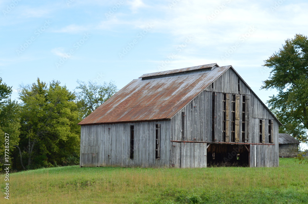 Rural landscape photo of an old rustic barn on a farm in the country