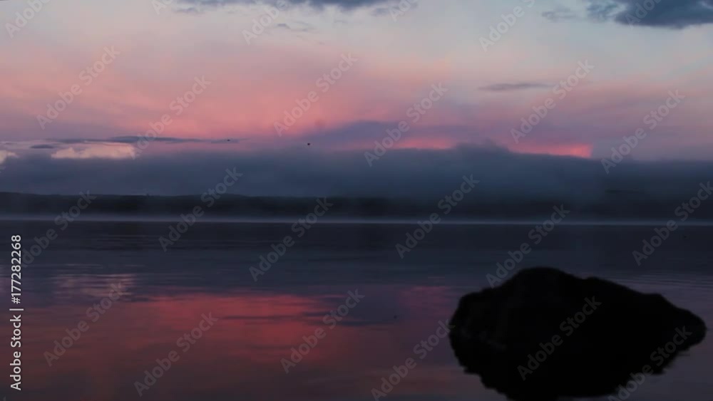 Pink and blue sunset on calm lake Pink and blue sunset on calm lake