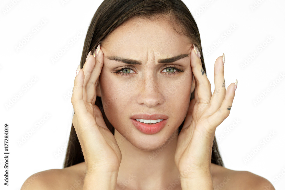 Woman holds fingers on her temples showing headache Woman holds fingers on her temples showing headache