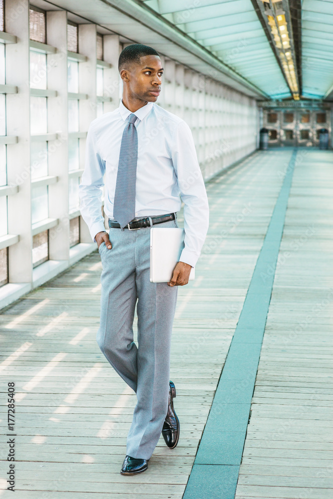 Dressing in a light blue shirt a pattern tie gray pants wearing glasses  a black college student is standing by a pattern wall with a window confi  Stock Photo  Alamy