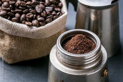 ground coffee with coffee bean on dark background