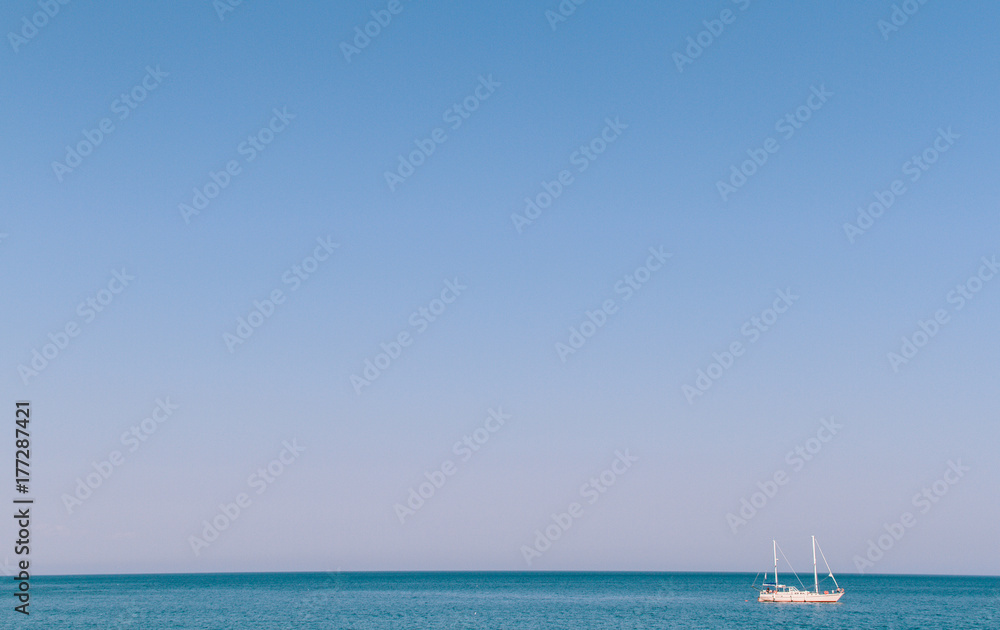 The yacht sails in the ocean on the horizon The yacht sails in the ocean on the horizon