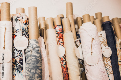 Rolls of natural high fashion fabrics and textiles. Sewing industry concept