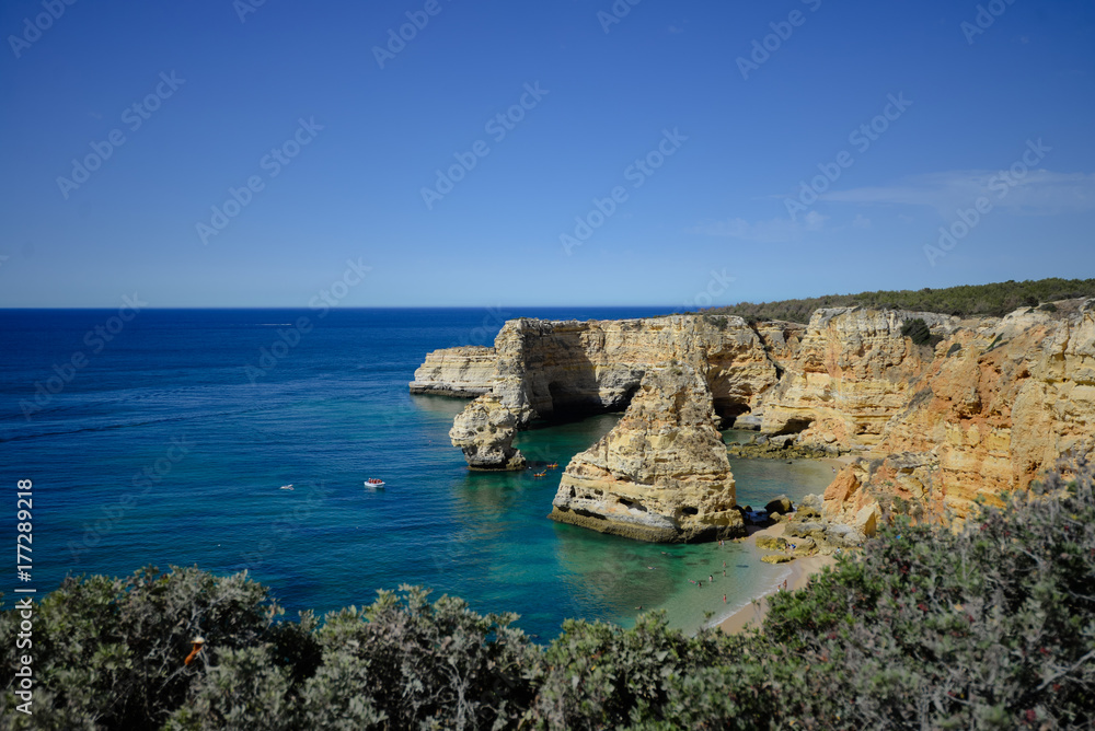 Algarve coastline and beautiful sunny cliffs ocean natural outdoors background. Idyllic dream travel destination