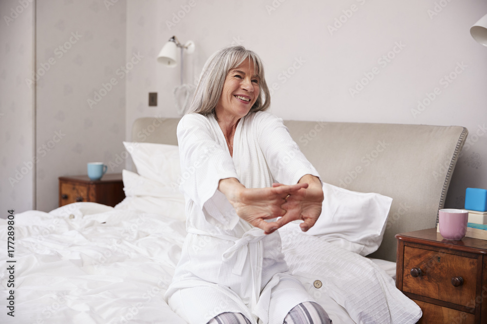 Senior Woman Waking Up And Stretching In Bedroom Senior Woman Waking Up And Stretching In Bedroom