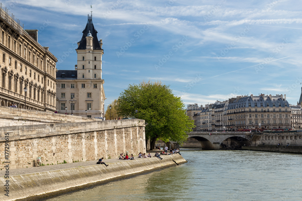 The picturesque embankments of the Seine in Paris, France. Buildings and trees