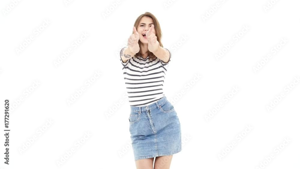 Young cheerful caucasian pretty lady dancing showing thumbs up and looking camera Young cheerful caucasian pretty lady dancing showing thumbs up and looking camera