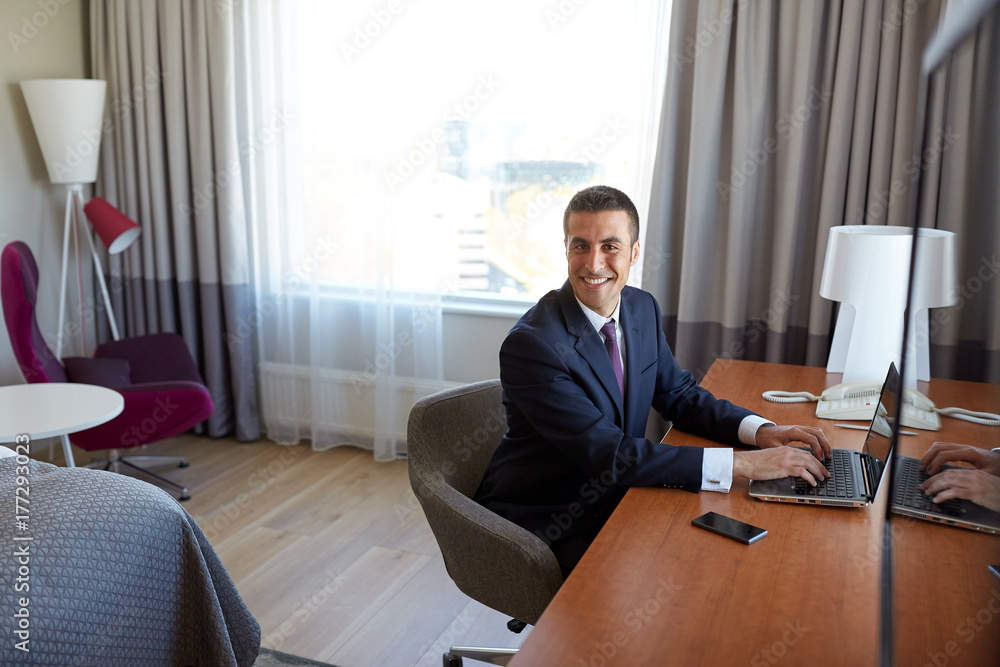 businessman typing on laptop at hotel room businessman typing on laptop at hotel room