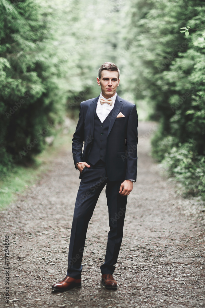 Young handsome man posing on mountain forest Young handsome man posing on mountain forest