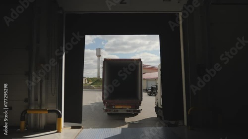 Truck with container is docked with loading area