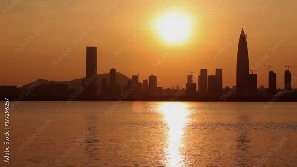 Urban skyline - cityscape at sunset; skyscrapers silhouettes back-lit by sunlight; Nanshan district, Shenzhen, Guangdong province, China; Urban skyline - cityscape at sunset; skyscrapers silhouettes back-lit by sunlight; Nanshan district, Shenzhen, Guangdong province, China;